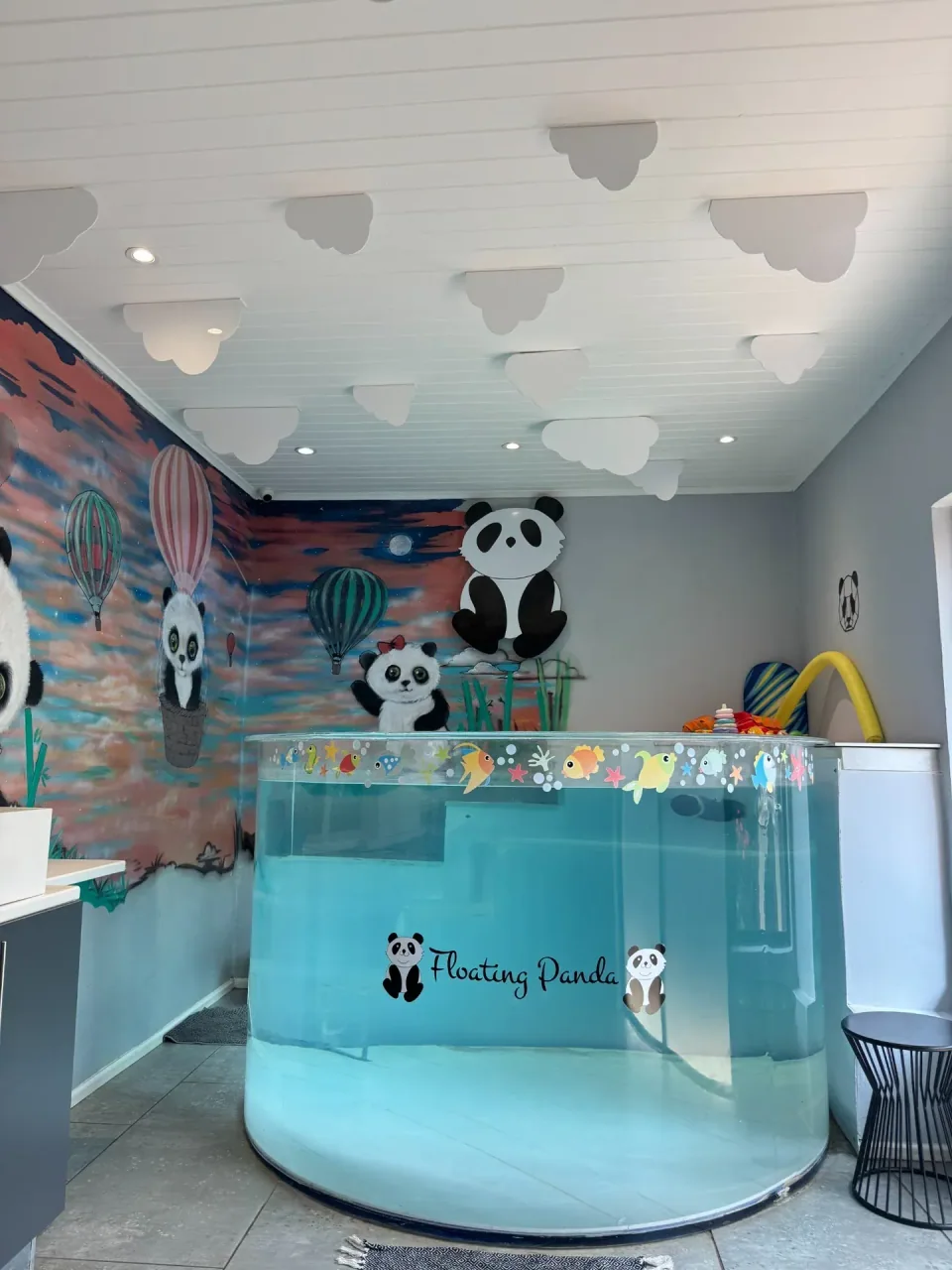 The round pool surrounded by colourful panda murals and ceiling clouds