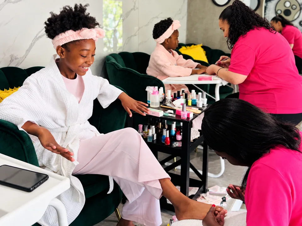 Children enjoying manicures and pedicures together at Floating Panda