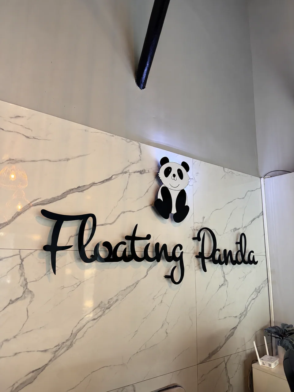 Floating Panda’s panda logo and lettering on the reception wall